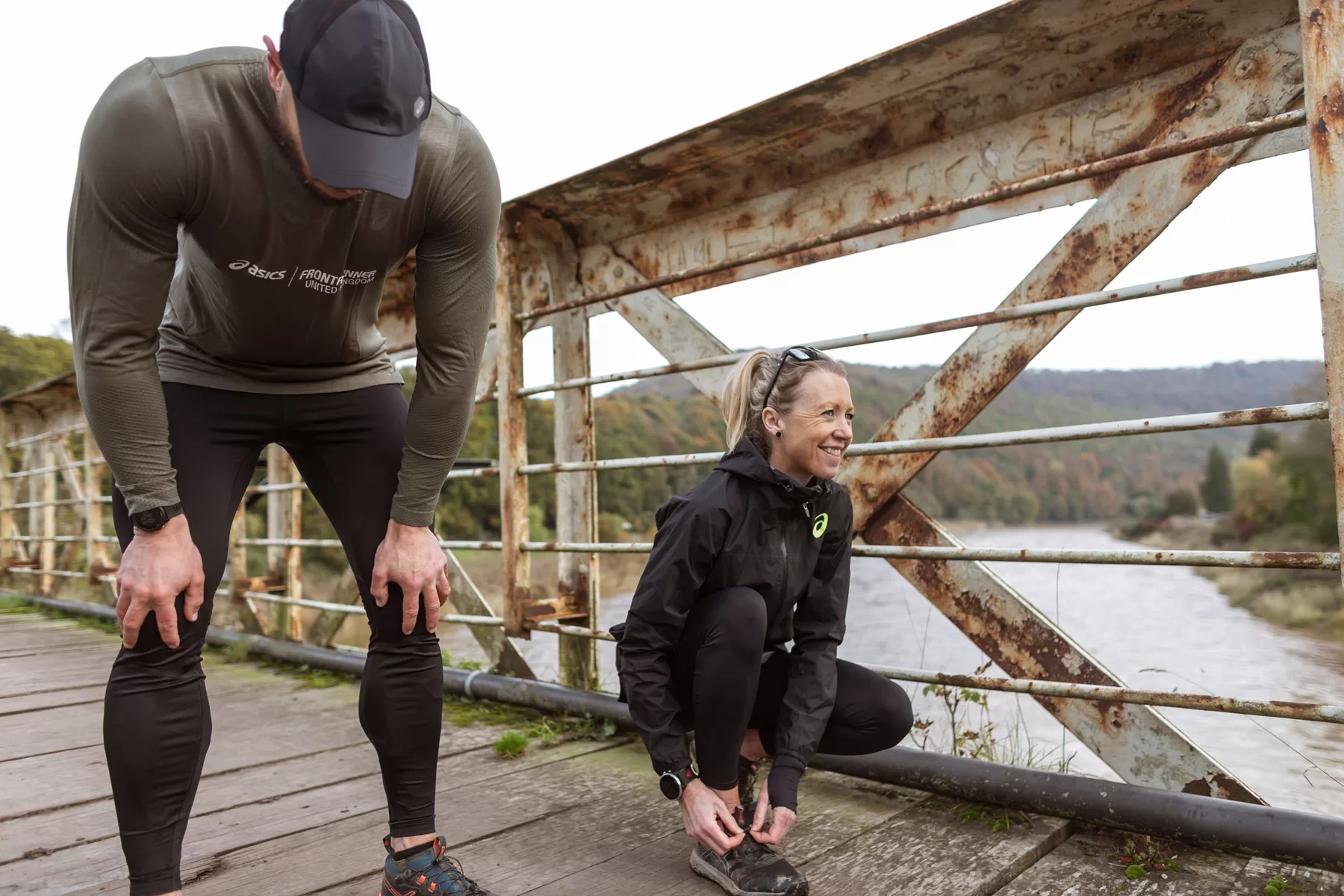 Man and woman runners on a bridge over a river shot by Bristol photographer Paris Penny