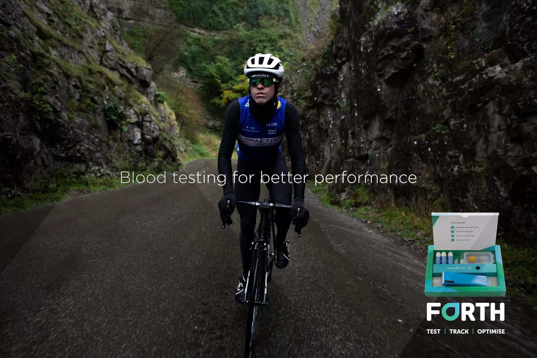 Man cycling up a Gorge in the rain with Blood testing kit in foreground - by Bristol photographer Paris Penny