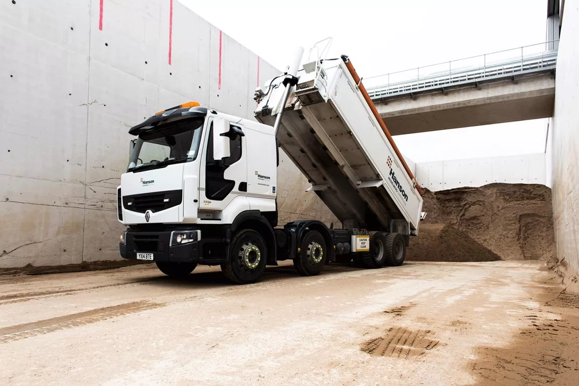 white Hanson 32 tone tipper lorry tipping out aggregate at Hinckley point shot by Photographer Bristol Paris Penny