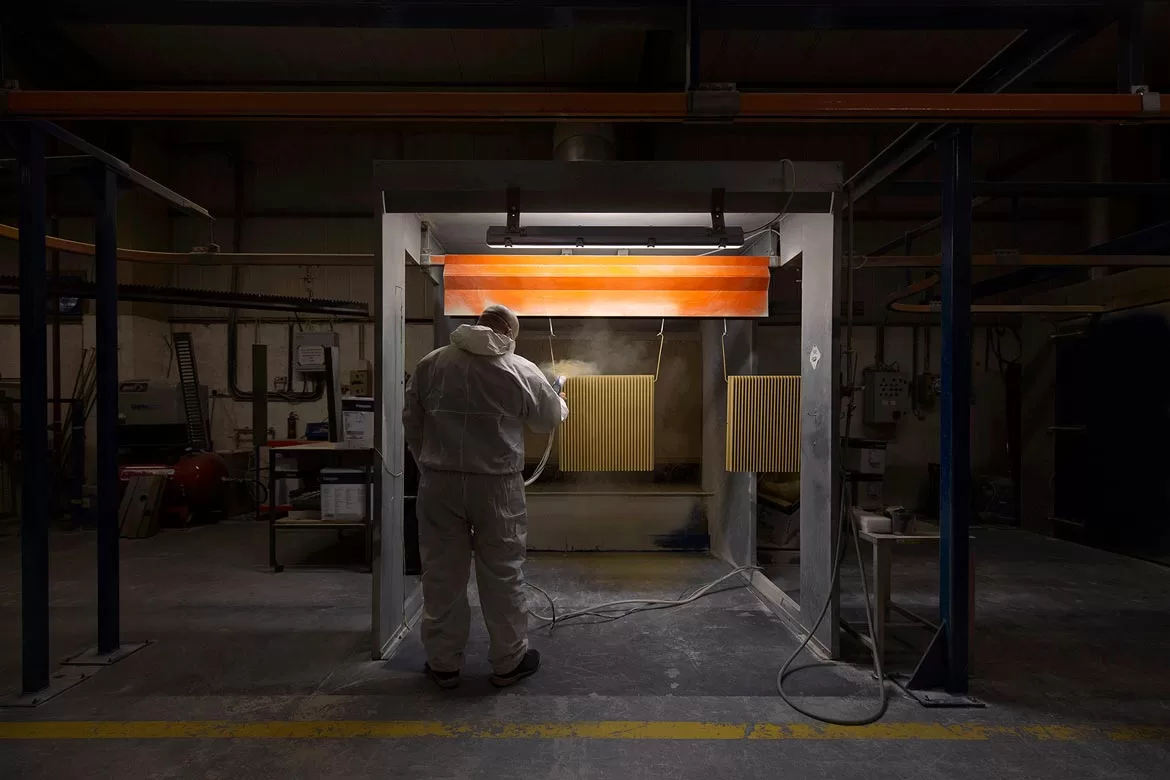 industrial photo of man spraying radiator shot by Bristol Photographer Paris Penny
