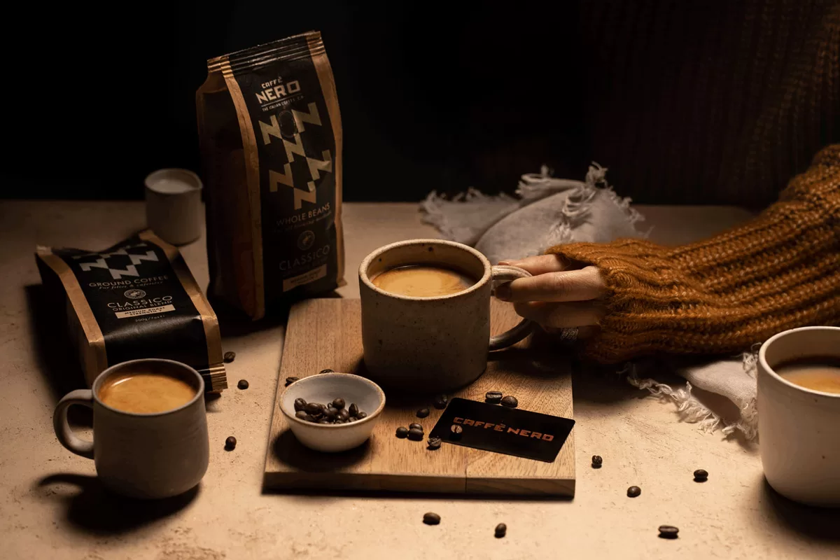 Coffee and packaging photographed in studio lighting with black and gold colour theme by Bristol Photographer Paris Penny