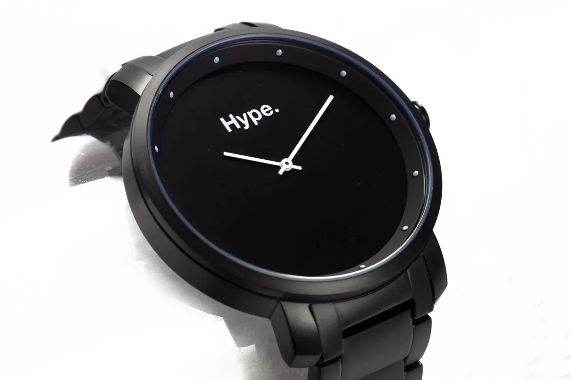 Product photo of grey watch with a black face and white hands. Shot on a white background by Bristol photographer Paris Penny Photography