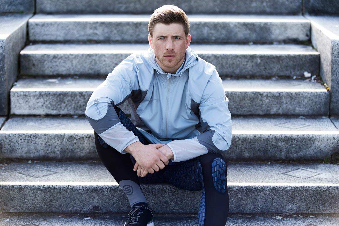 Portrait of man sat on steps in Skinns gym gear